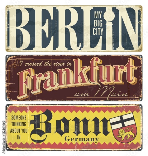 Vintage tin sign collection Germany cities. Berlin. Frankfurt. Bonn. Germany. Capital. Retro souvenirs or postcard templates on rust background.