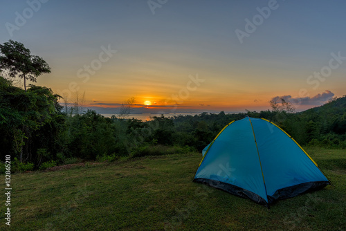 Tourist tent in camp among meadow in the mountain at sunrise © yotrakbutda