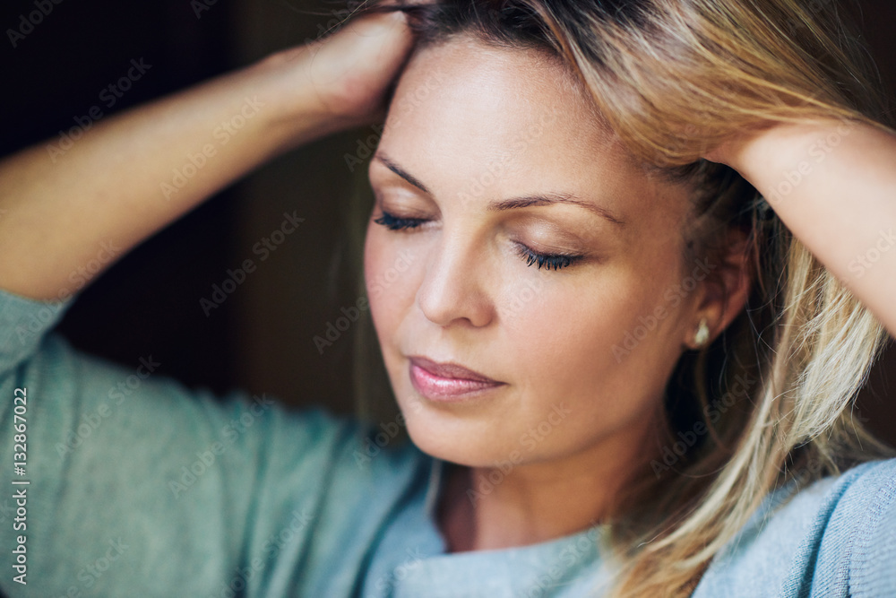 Fototapeta premium Beautiful woman feeling her soft blond hair