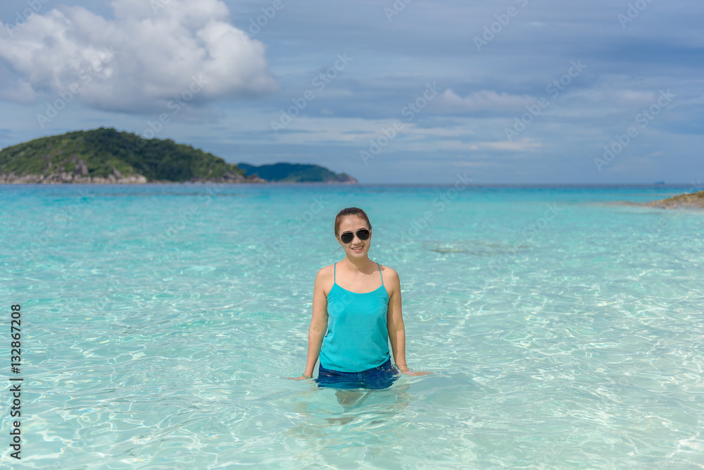 Woman standing in the turquoise water