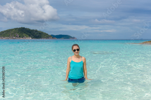 Woman standing in the turquoise water