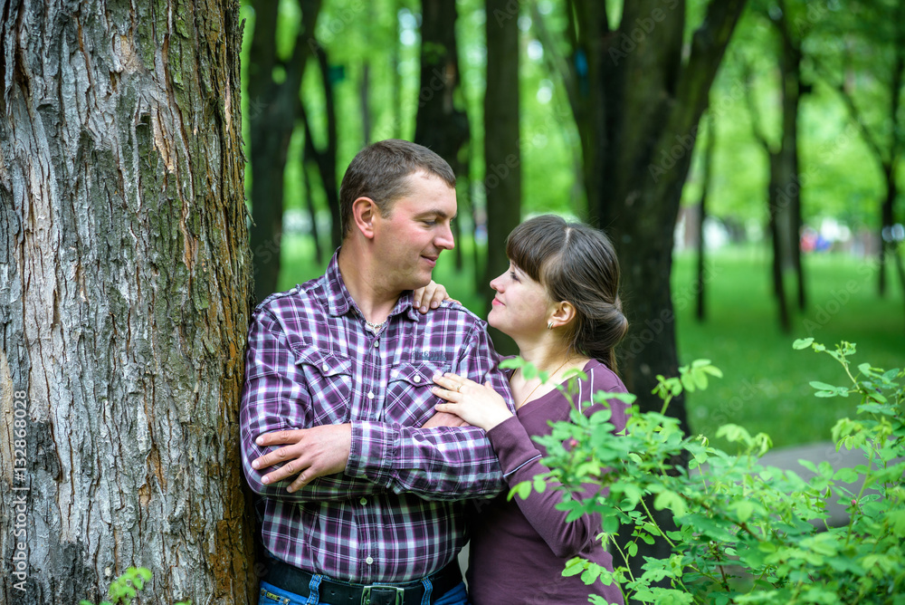 Loving young couple walk on the park at summer. Loving young couple walk on the park at summer.