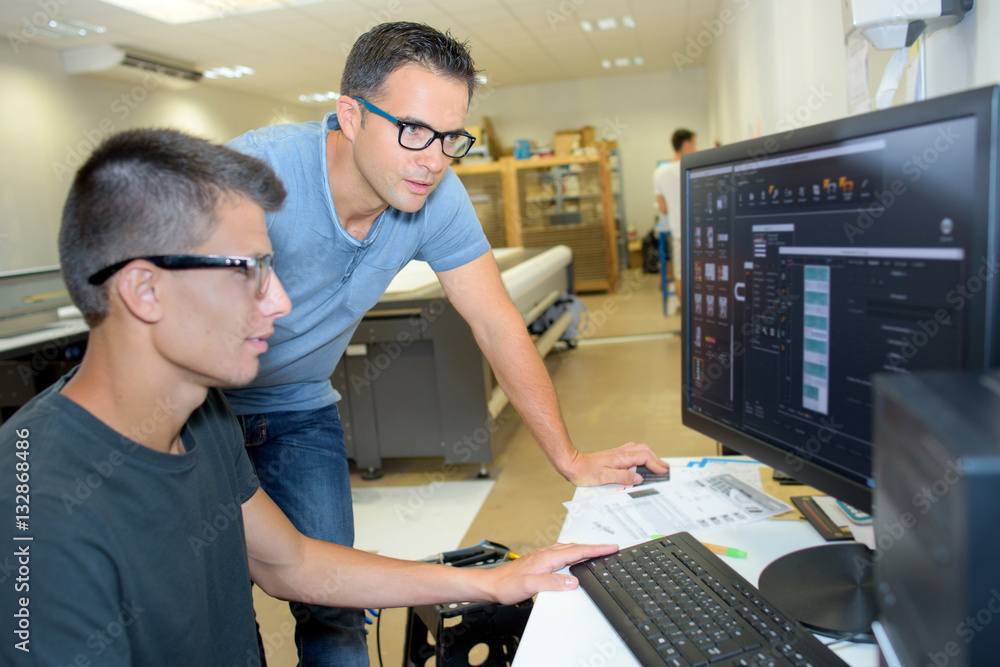 teacher and student working on computer Stock-Foto | Adobe Stock