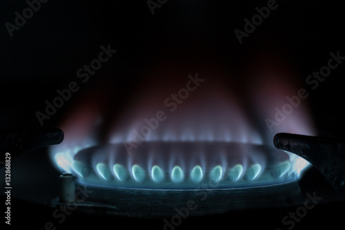 Natural gas burns with a blue flame photo