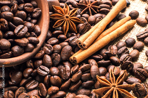 Coffee beans into bowl with cinnamon and anise
