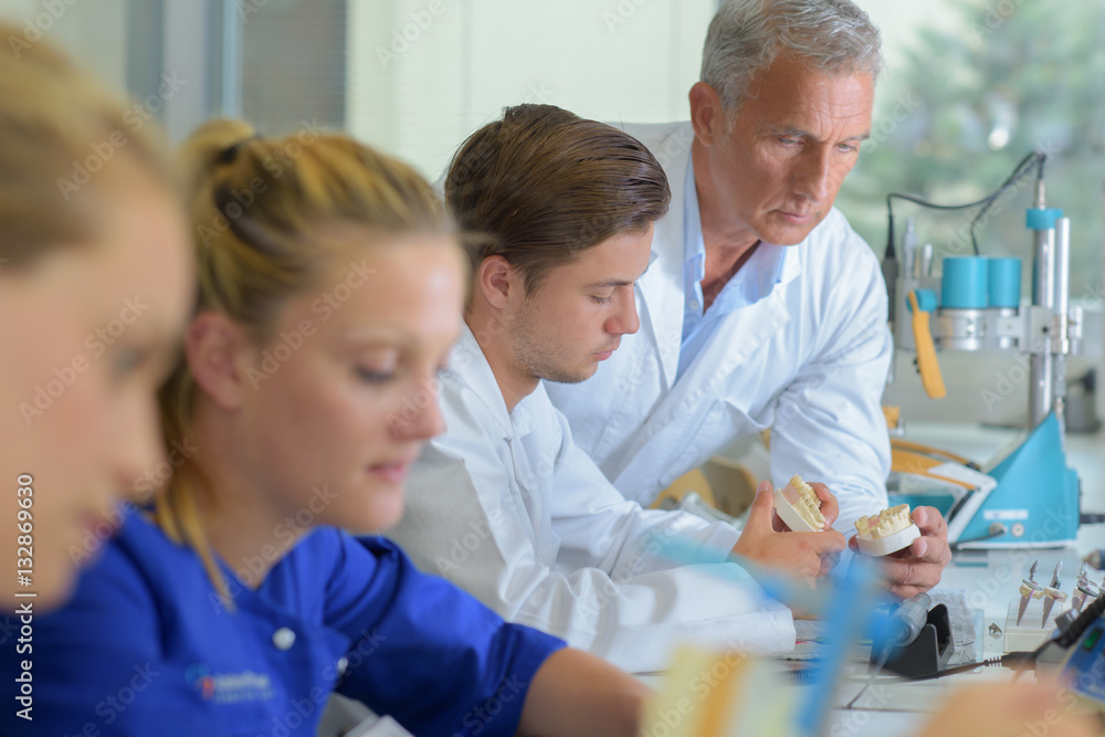 Obraz premium Supervisor checking dentures in lab