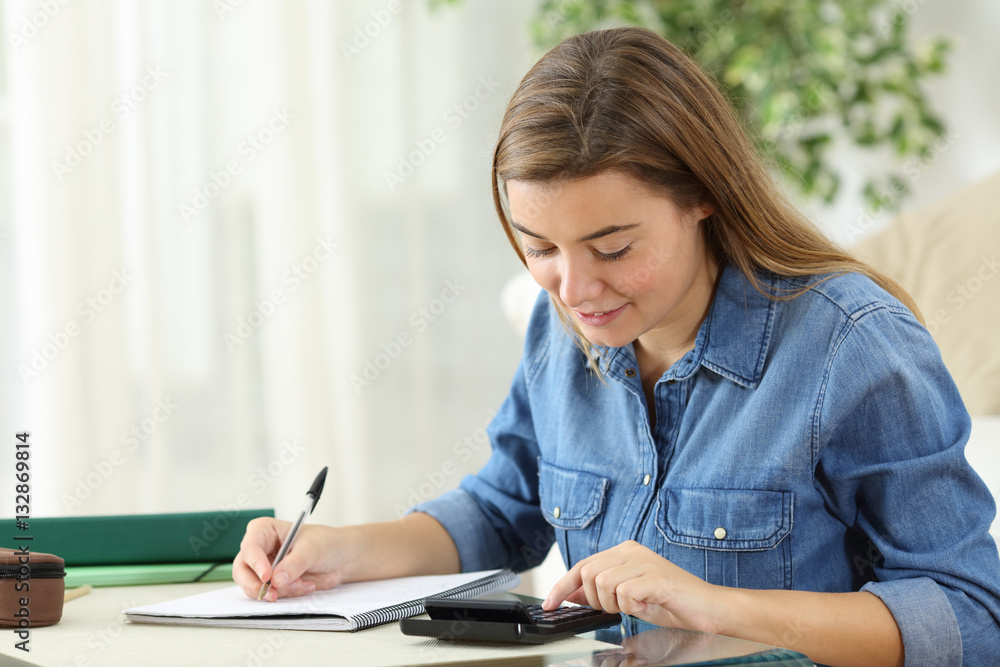 Student studying calculating with a calculator Student studying calculating with a calculator