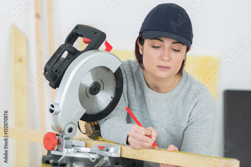 woman with circular saw in workshop © auremar