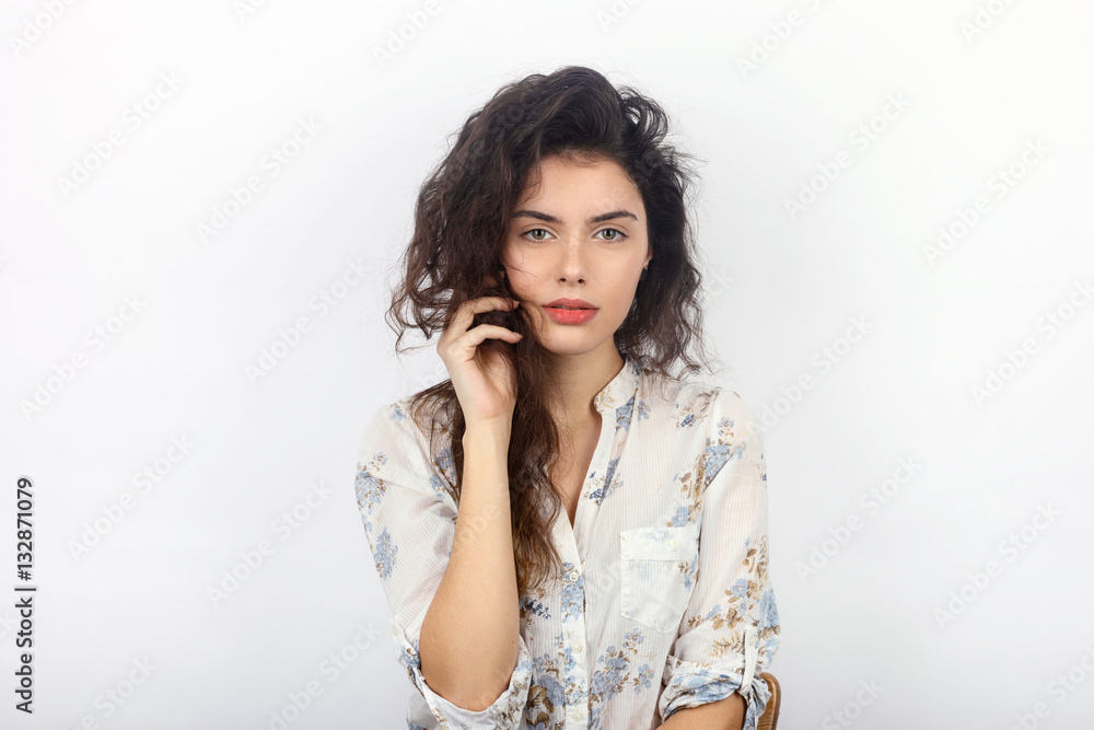 Beauty portrait of young beautiful cheerful young fresh looking woman with long brown healthy curly hair. Concept on white background. Beauty portrait of young beautiful cheerful young fresh looking woman with long brown healthy curly hair. Concept on white background.