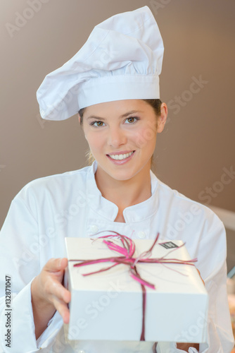 Patisserie chef holding a gift box