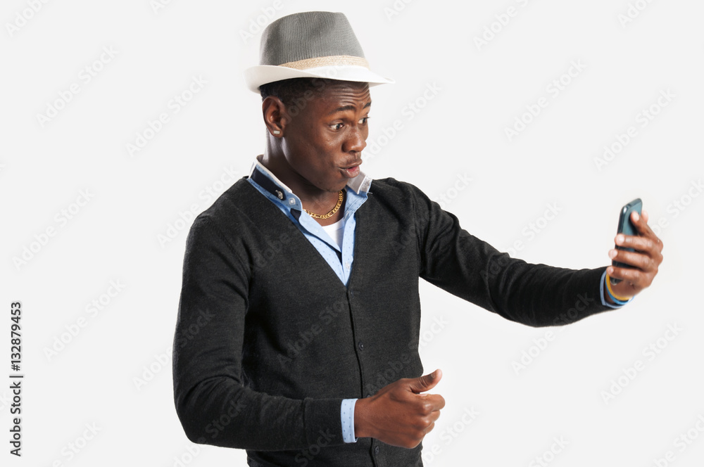 Portrait of surprised young african guy looking at cell phone Portrait of surprised young african guy looking at cell phone
