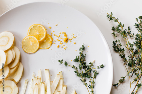 Raw ingredients on white plate, overhead view
