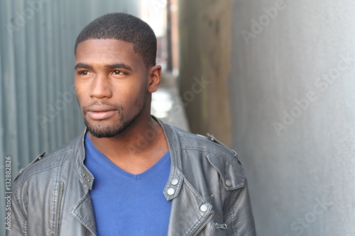 Close-up of handsome young, dark-skinned man looking away