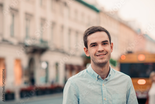 Smiling young man standing in the city