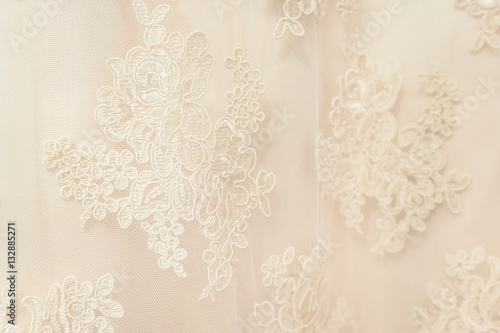 Background, texture, embroidered lace. Delicate detail of a wedding dress. Fine lace
