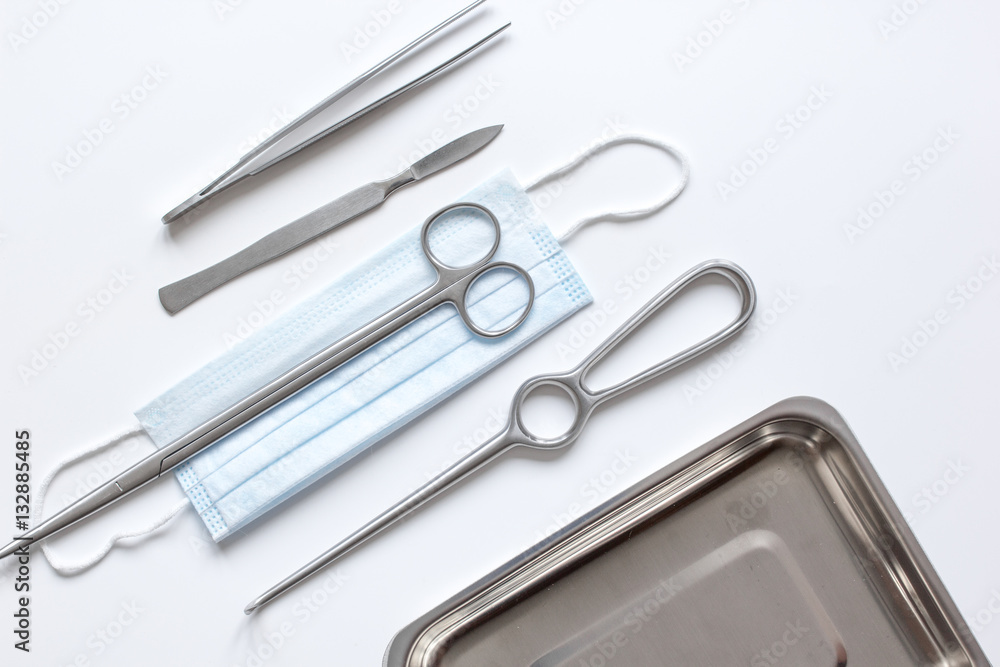 instruments for plastic surgery on white background top view instruments for plastic surgery on white background top view