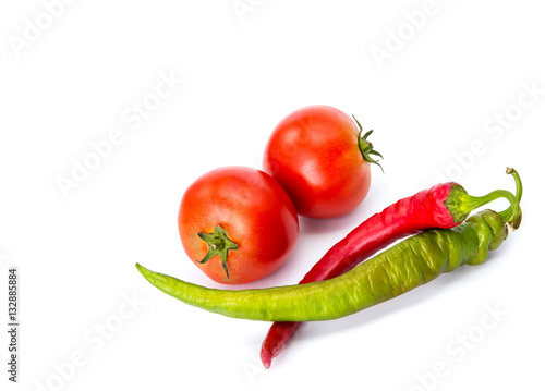 Isolated ketchup ingredients. Fresh tomatoes and hot peppers isolated on white background