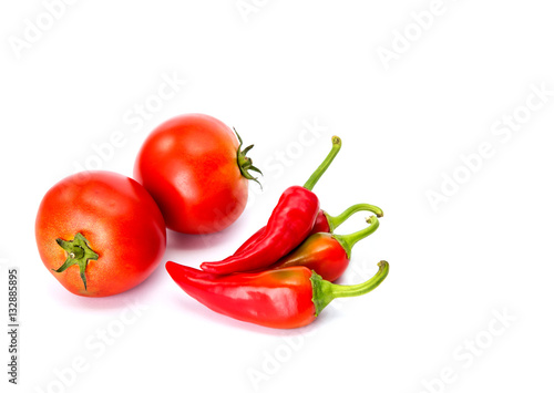 Isolated ketchup ingredients. Fresh tomatoes and hot peppers isolated on white background