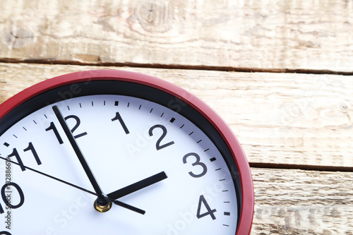 Wallpaper Mural Red round clock on a grey wooden table Torontodigital.ca