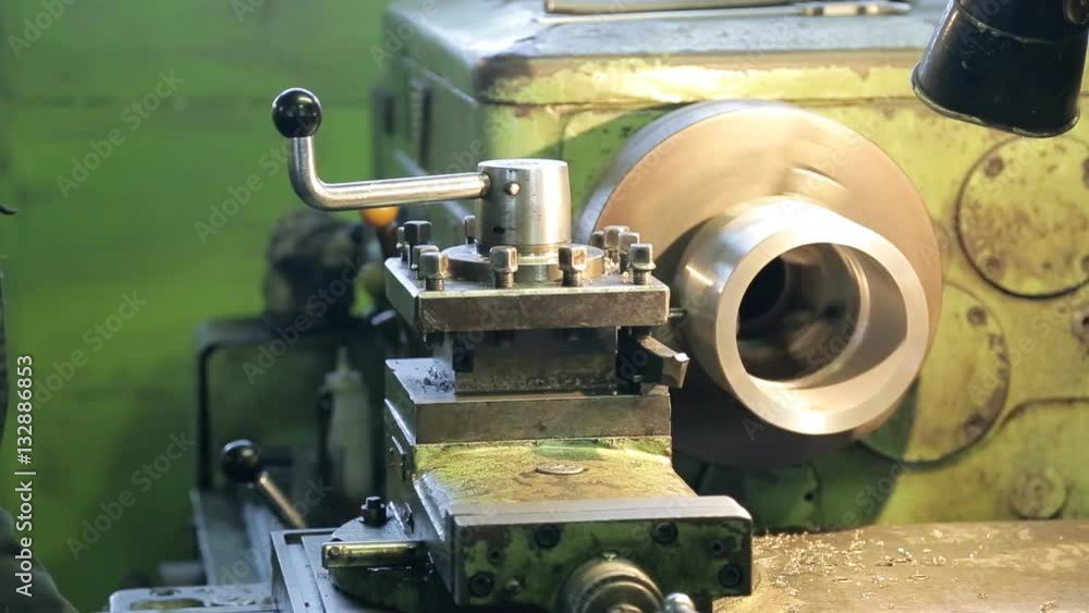 Worker triggers mechanism on factory, engineering industry Worker triggers mechanism on factory, engineering industry