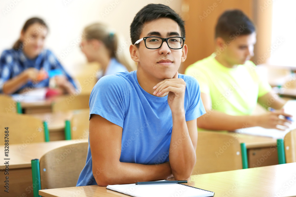Student with group of classmates in classroom Student with group of classmates in classroom