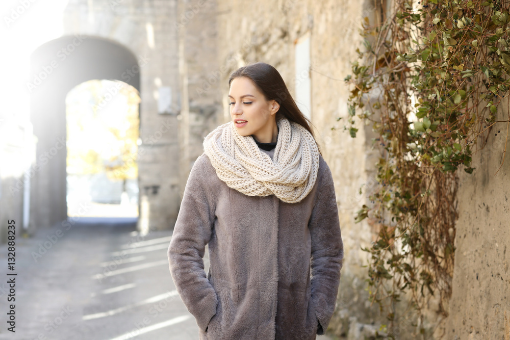 Beautiful young woman near old building on sunny autumn day Beautiful young woman near old building on sunny autumn day