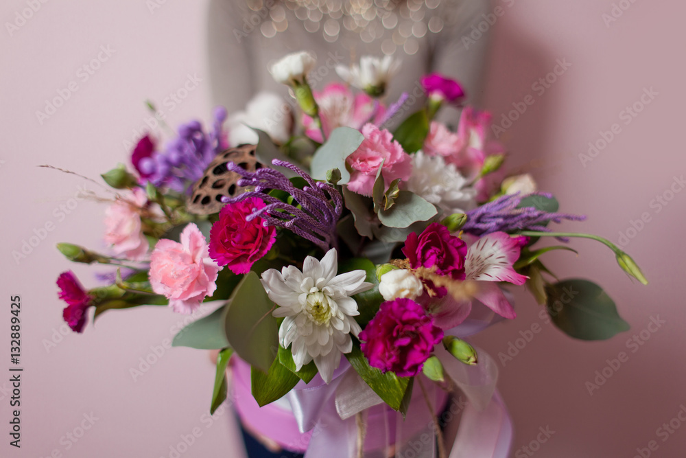 A womans hand is holding a bouquet of flowers A womans hand is holding a bouquet of flowers