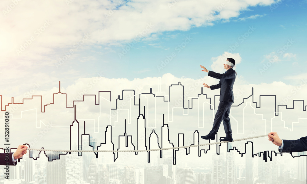 Business concept of risk support and assistance with man balancing on rope Business concept of risk support and assistance with man balancing on rope