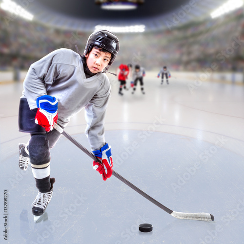 Junior Ice Hockey Player in Crowded Arena