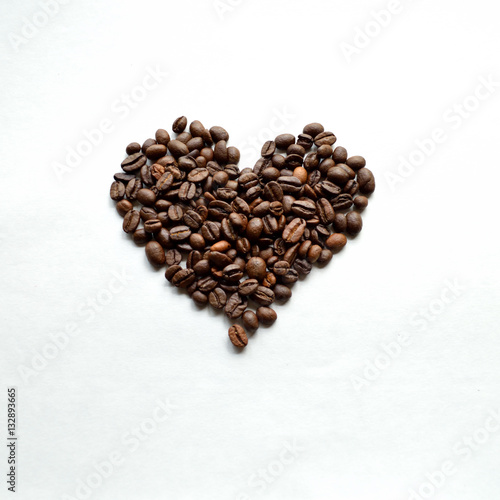 Coffee bean heart against white