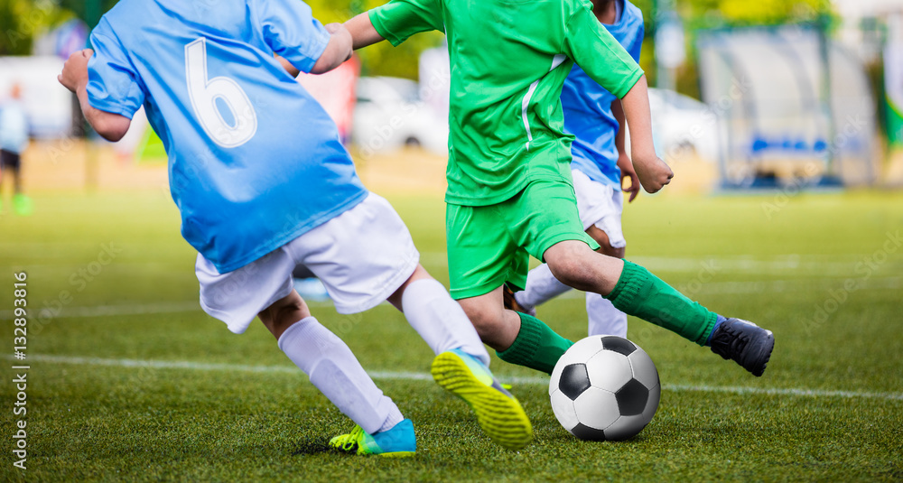Obraz premium Soccer Football Match. Young Boys Kicking Football Ball on the Sports Field. Kids Playing Soccer Tournament Game on the Pitch