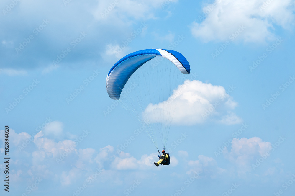 Paraglider flying in the sky on a paraglider. Paragliding. Paraglider flying in the sky on a paraglider. Paragliding.