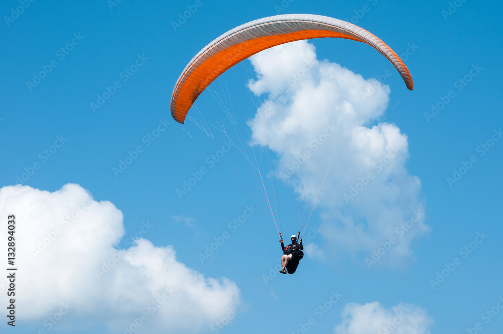 Paraglider flying in the sky on a paraglider. Paragliding. Paraglider flying in the sky on a paraglider. Paragliding.