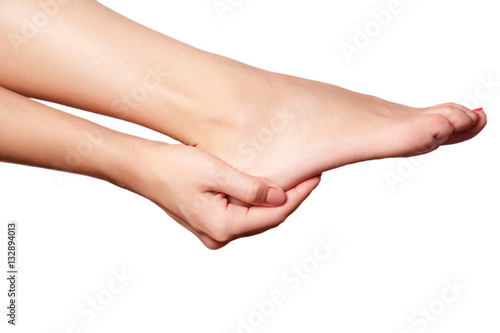 Closeup view of a young woman with pain on leg. isolated on white background. 