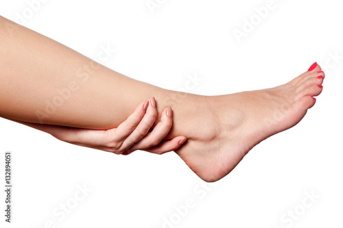Closeup view of a young woman with pain on leg. isolated on white background. 