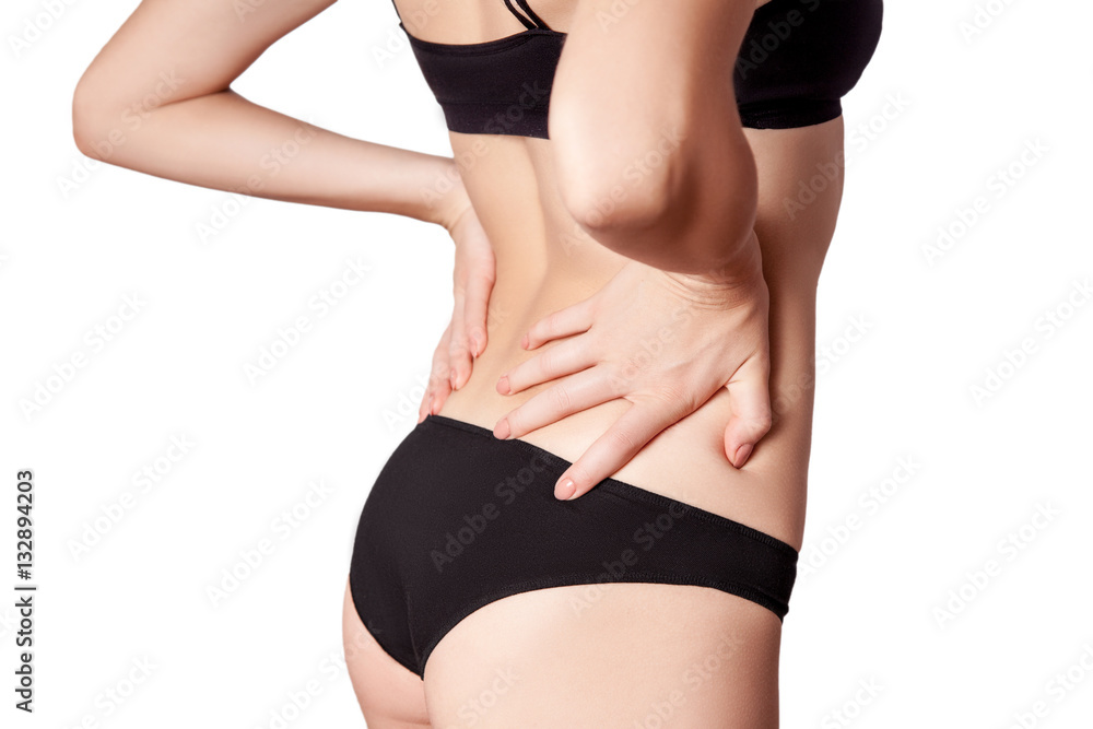 Fototapeta premium Closeup view of a young woman with pain in back. isolated on white background.