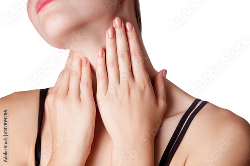 Closeup view of a young woman with pain on neck or thyroid gland. isolated on white background.
 photo