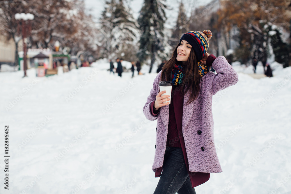 Girl walking the winter street and drinking coffee Girl walking the winter street and drinking coffee