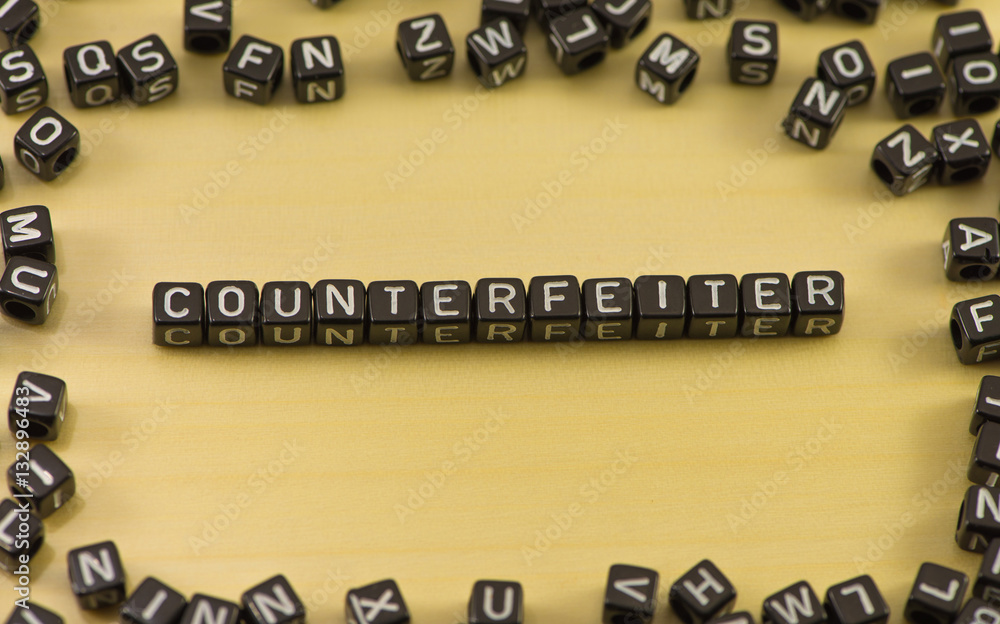 The word counterfeit on wood background The word counterfeit on wood background