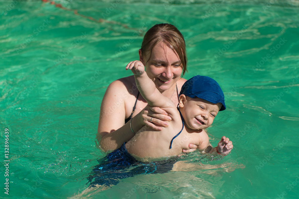 beautiful young mother with son in water