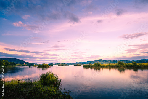 Fototapeta Naklejka Na Ścianę i Meble -  Sunset on the river and green meadow .
