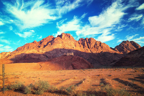 House on hill in desert next to mountain. Beautiful landscape. © twomeerkats