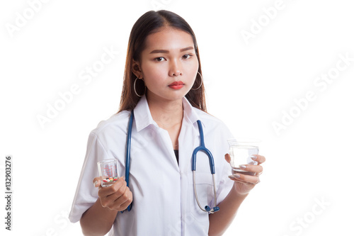 Young Asian female doctor with water and medicine.