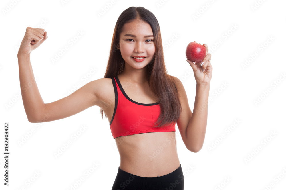 Beautiful Asian healthy girl flexing biceps with apple. Beautiful Asian healthy girl flexing biceps with apple.