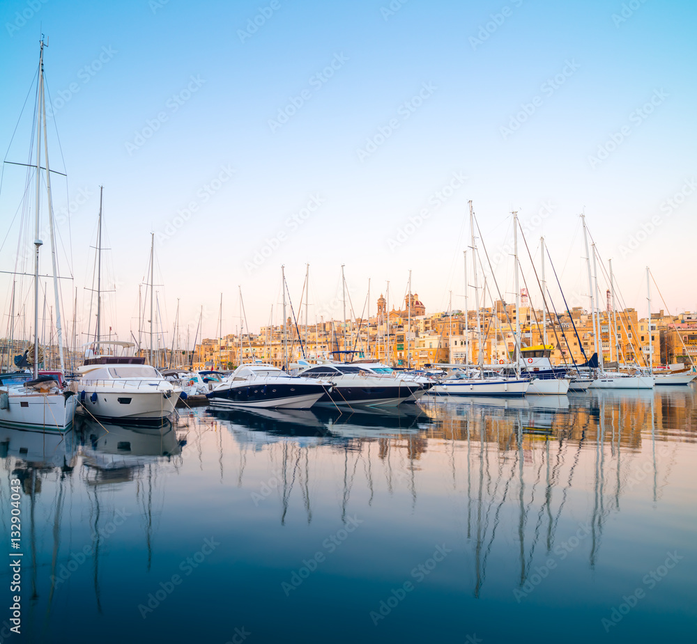 Fototapeta premium Sailing boats on Senglea marina in Grand Bay, Valetta, Malta