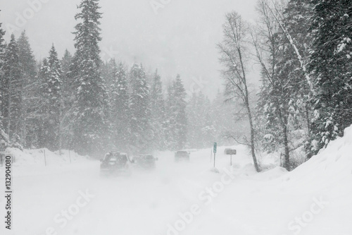 Foto Line of trucks driving in a Colorado blizzard