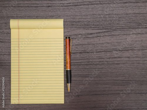 Dark Wood Desk, Yellow Pad, Pen on Desk