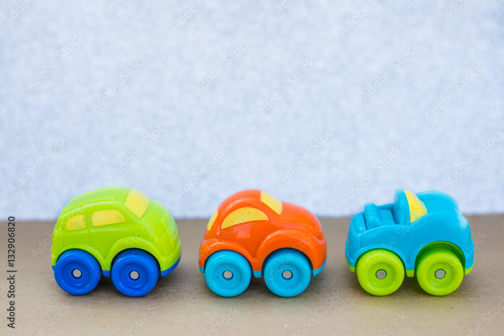 Model car toy on isolated white silver glitter background. Different colored cars. Model car toy on isolated white silver glitter background. Different colored cars.