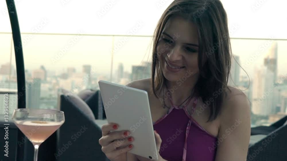 Young, happy woman using tablet computer on terrace in bar, super slow motion 120fps
Young, happy woman using tablet computer on terrace in bar, super slow motion 120fps