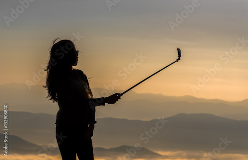 Silhouette of woman take photos oneself. Filter effect style